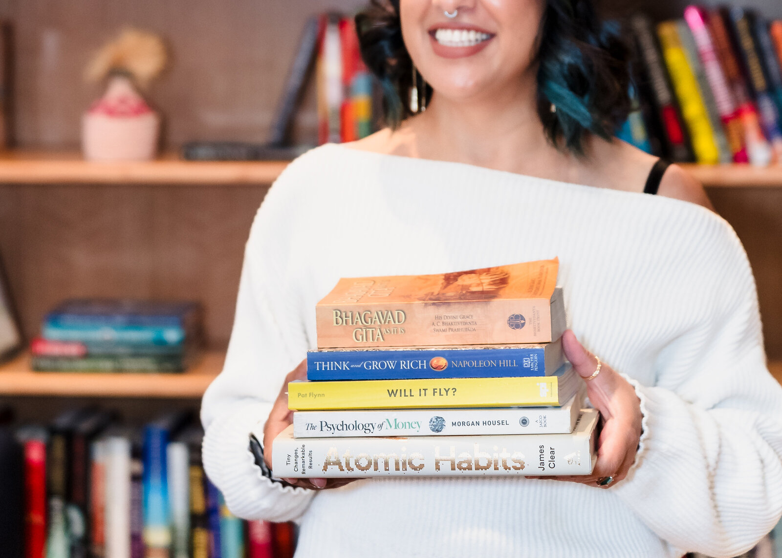 Business Coach holds books