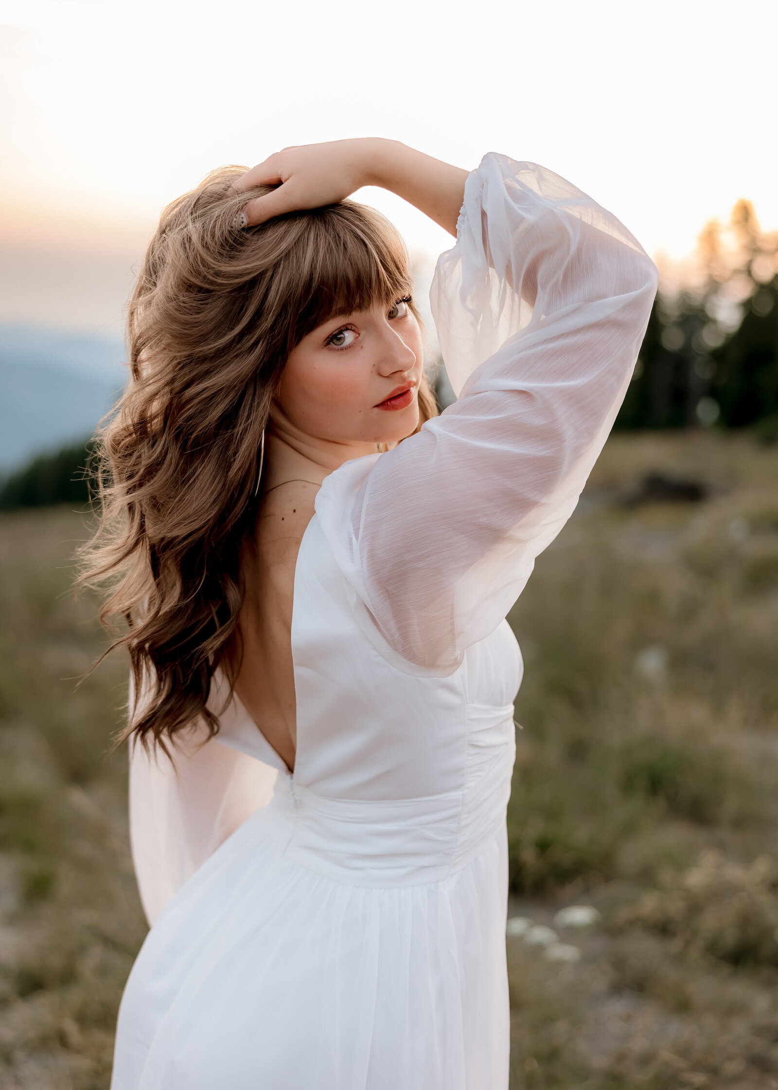 sandy high school senior doing senior portraits at sunset at timberline lodge.