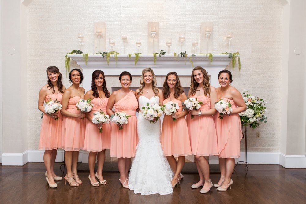 Gorgeous bridesmaid in coral dress with bouquet