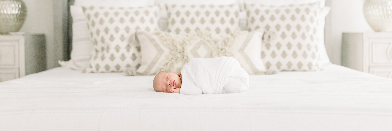 Newborn baby boy laying on bed