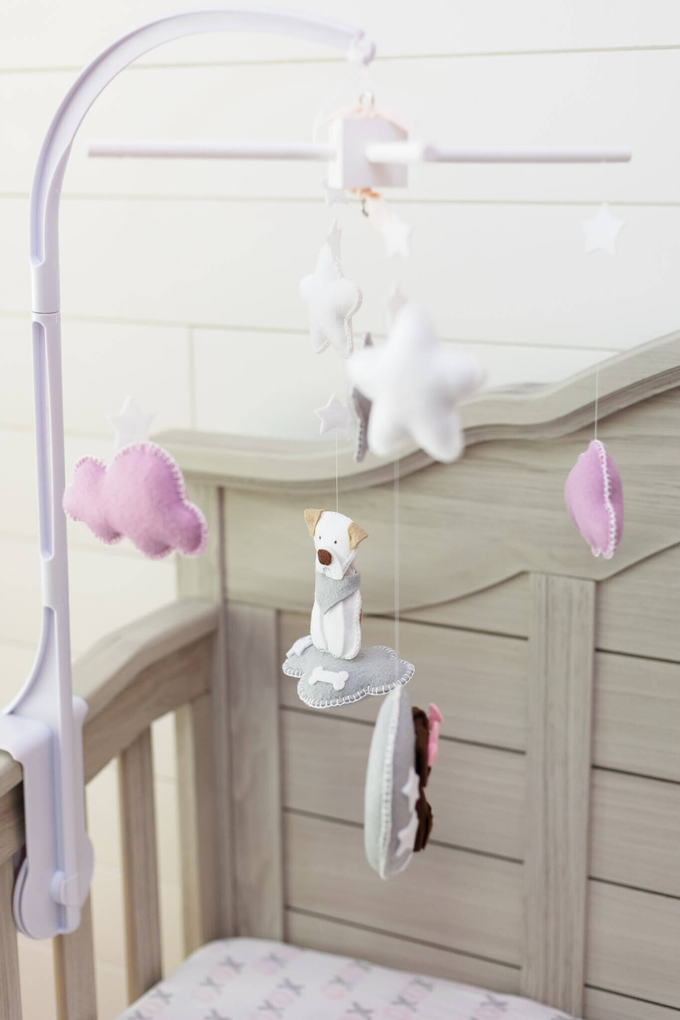 A close-up featuring the crib's mobile.