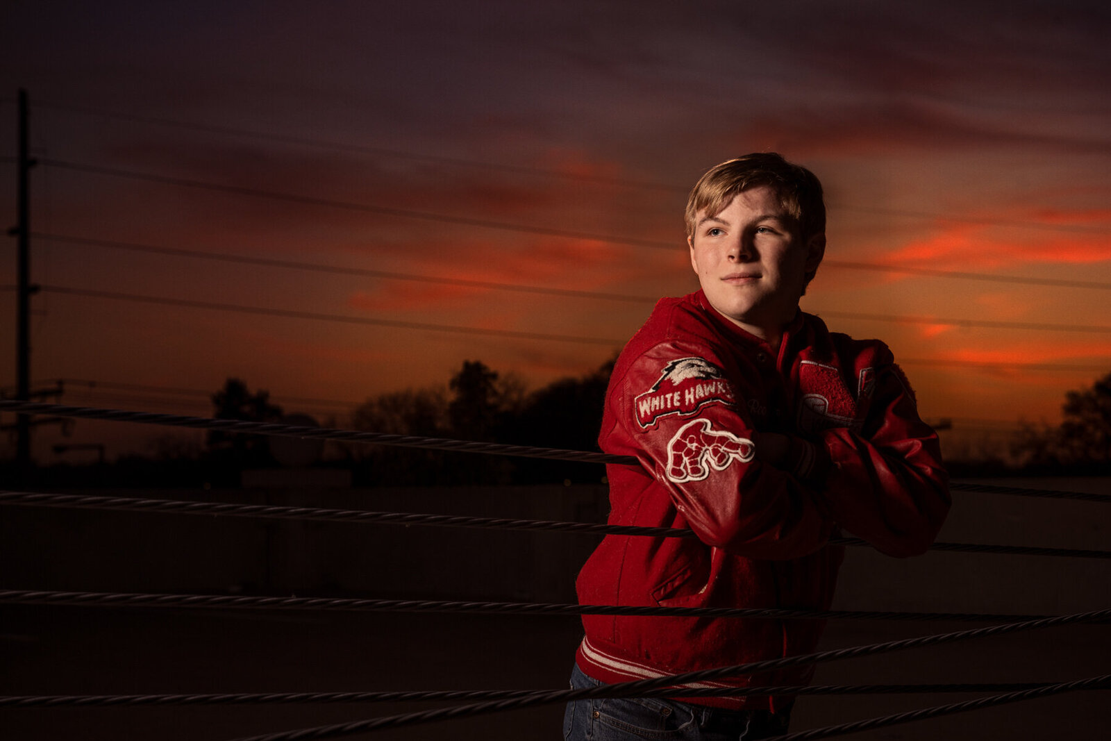 Mound Minnesota high school senior photo of boy in letter jacket at sunset