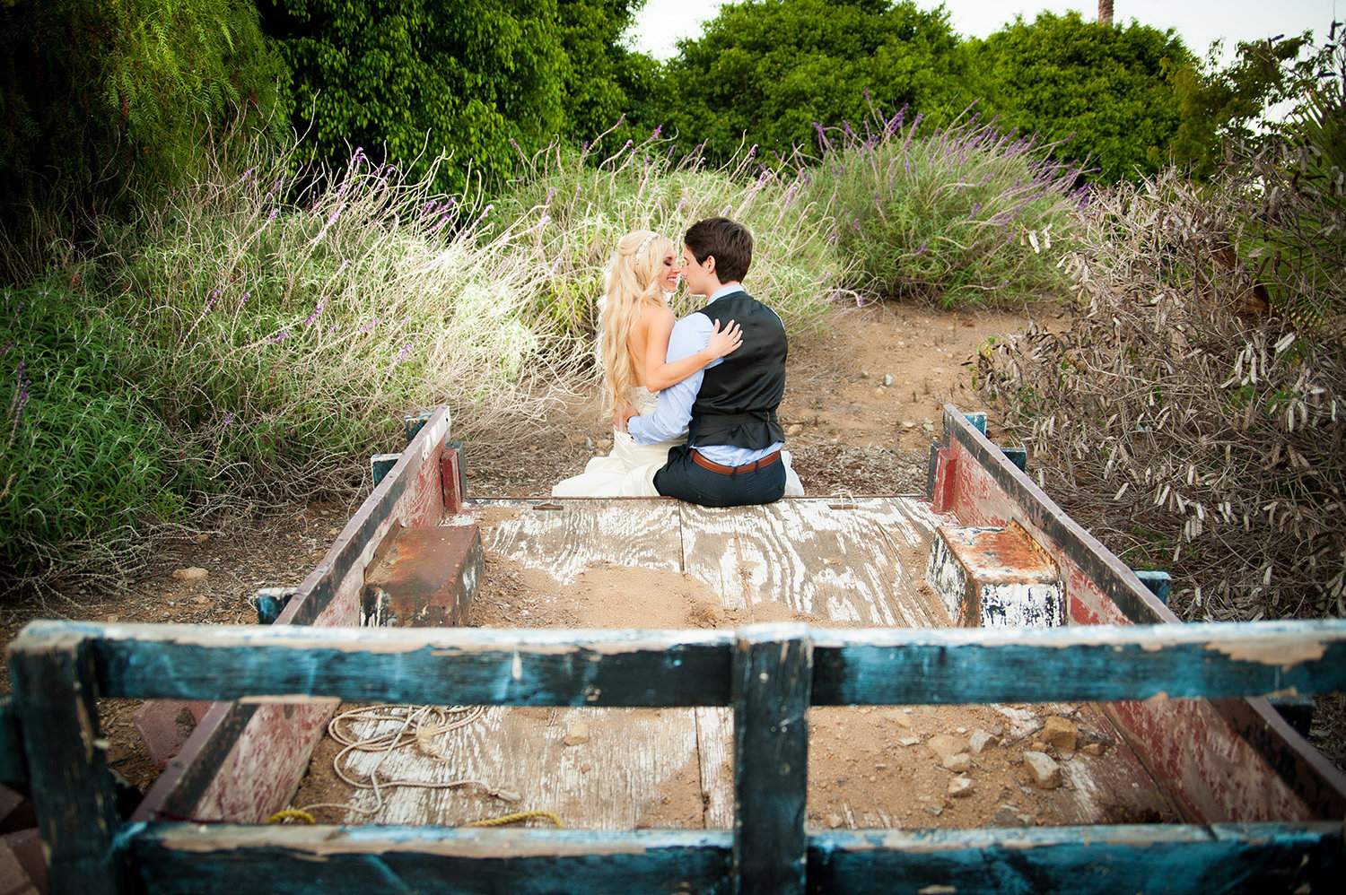 Sweet moment on the back of a trailer with the bride and groom