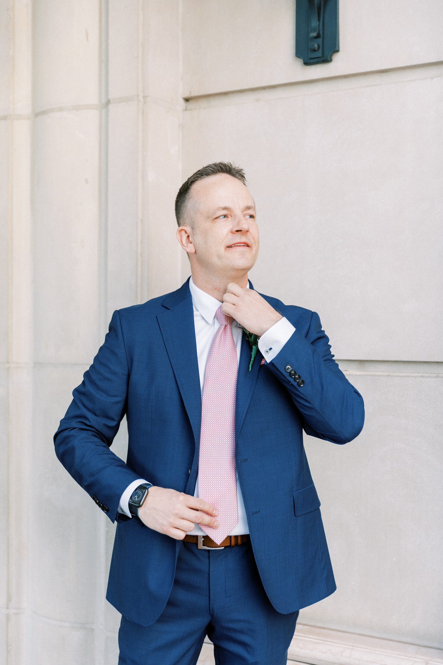 Groom straightens tie before his DC wedding