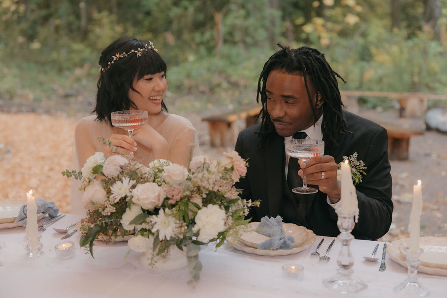 Bride and groom sharing a romantic moment at their wedding table