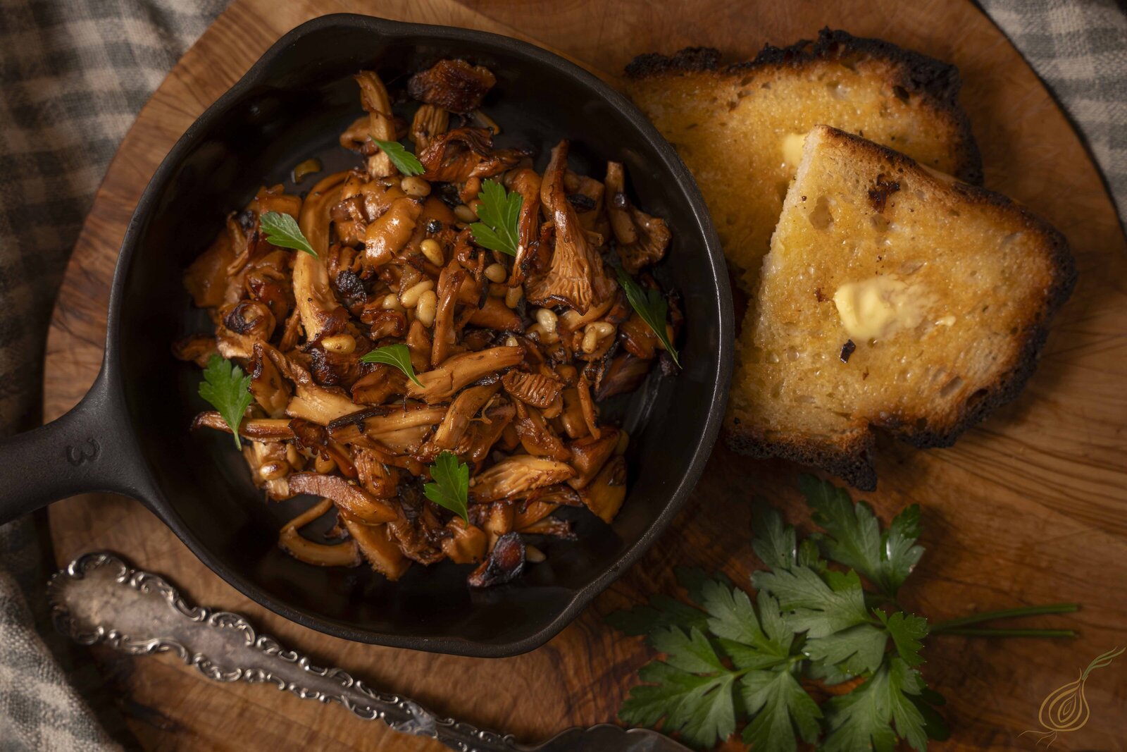 A skillet filled with golden-brown bread and sautéed mushrooms, highlighting a delightful cooking scene.