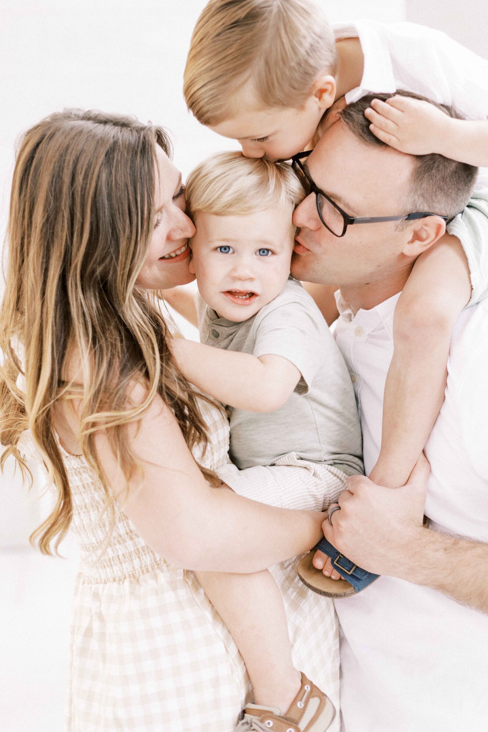 family hugging smallest child during peoria illinois family photos 