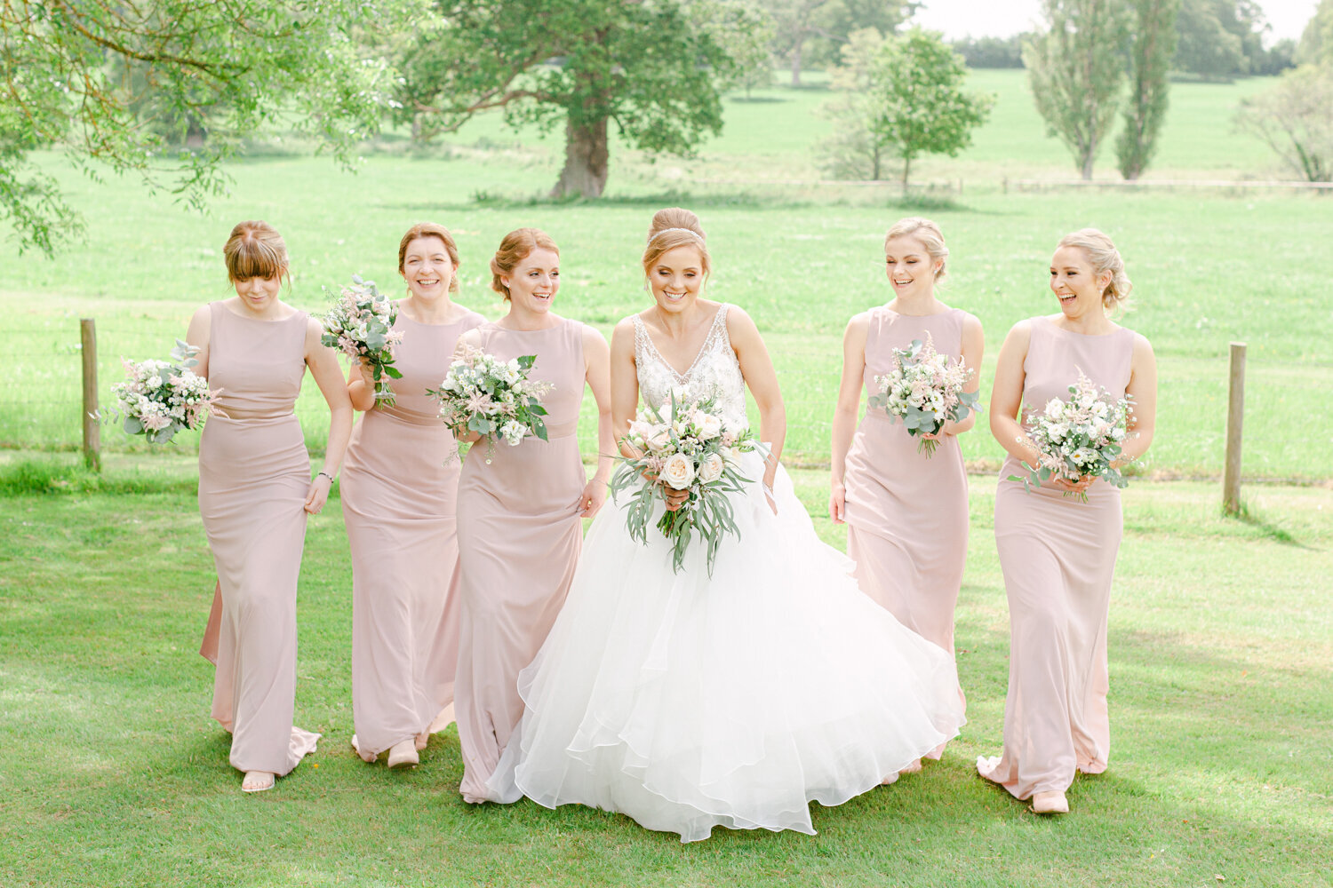 Fine Art Bride with her Bridesmaids walking to the wedding reception. Light and Airy Style Photography