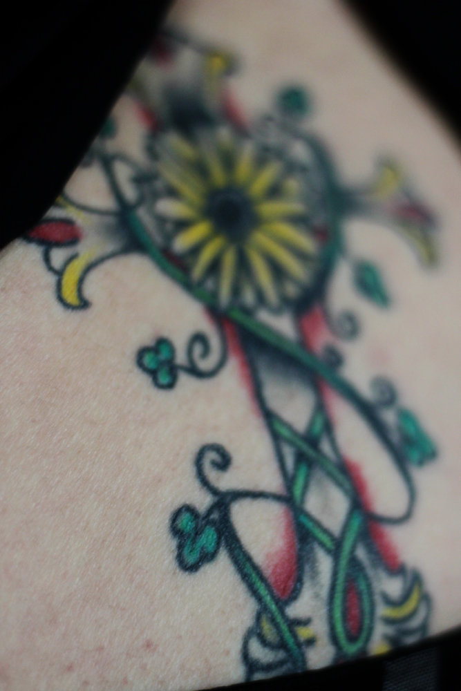 Tattoo, back, tramp stamp, cross, flowers