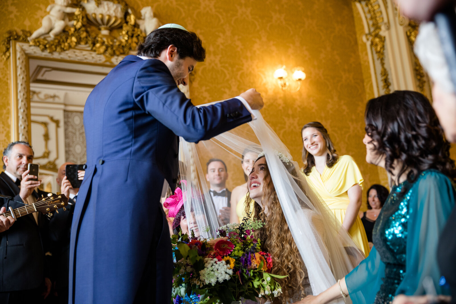 Groom lifts veil of the Bride  in jewish ceremony