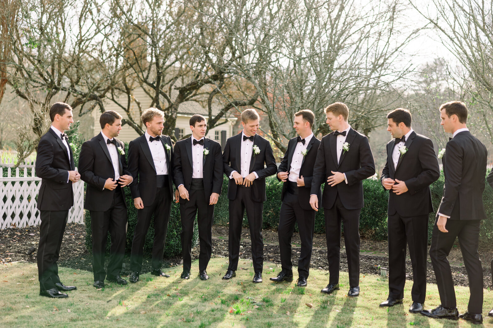Groom and groomsmen pose in a mix of formal and playful moments at Inola in Blue Ridge, GA, celebrating friendship and camaraderie on the wedding day.
