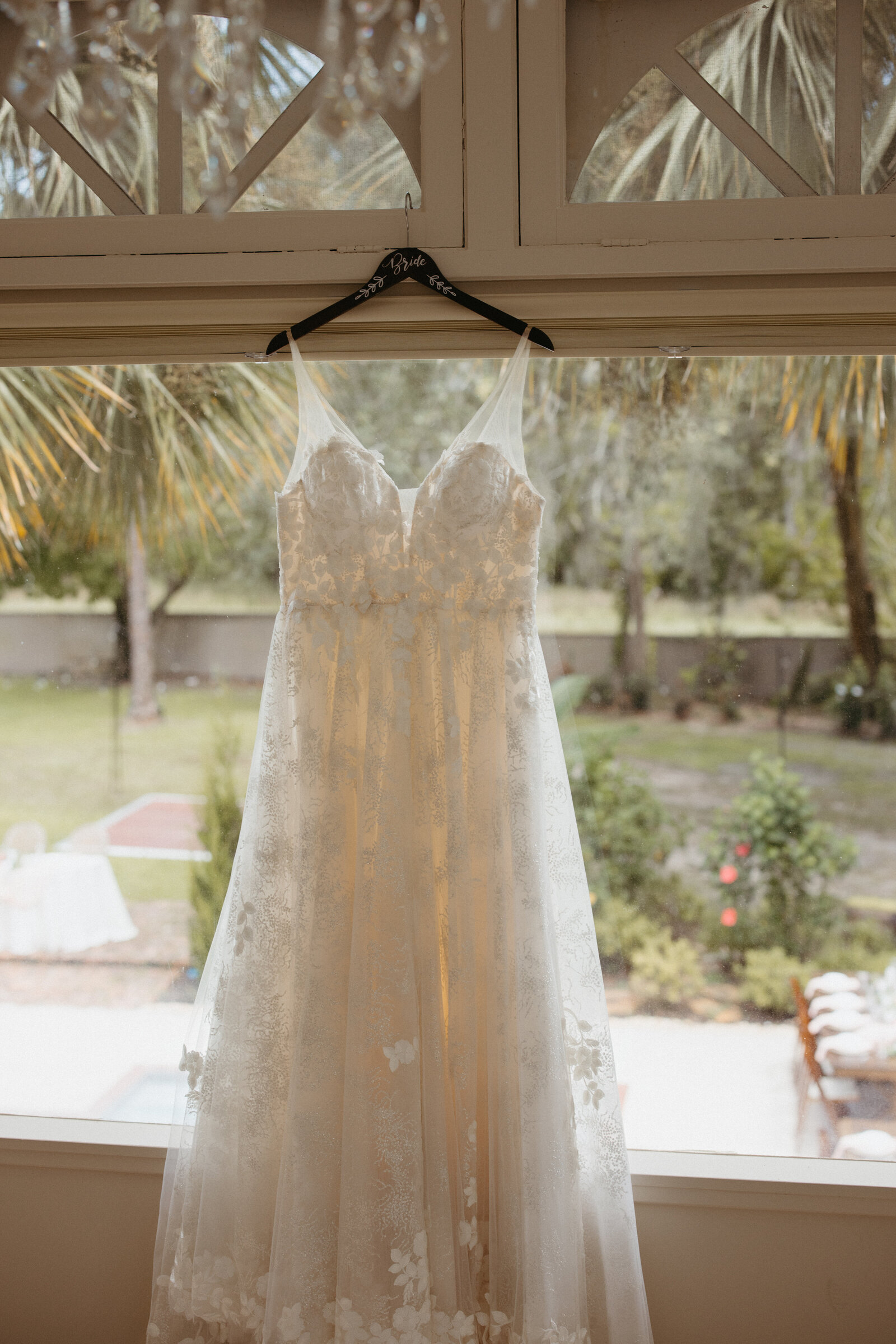 Wedding dress hanging in the bridal suite window