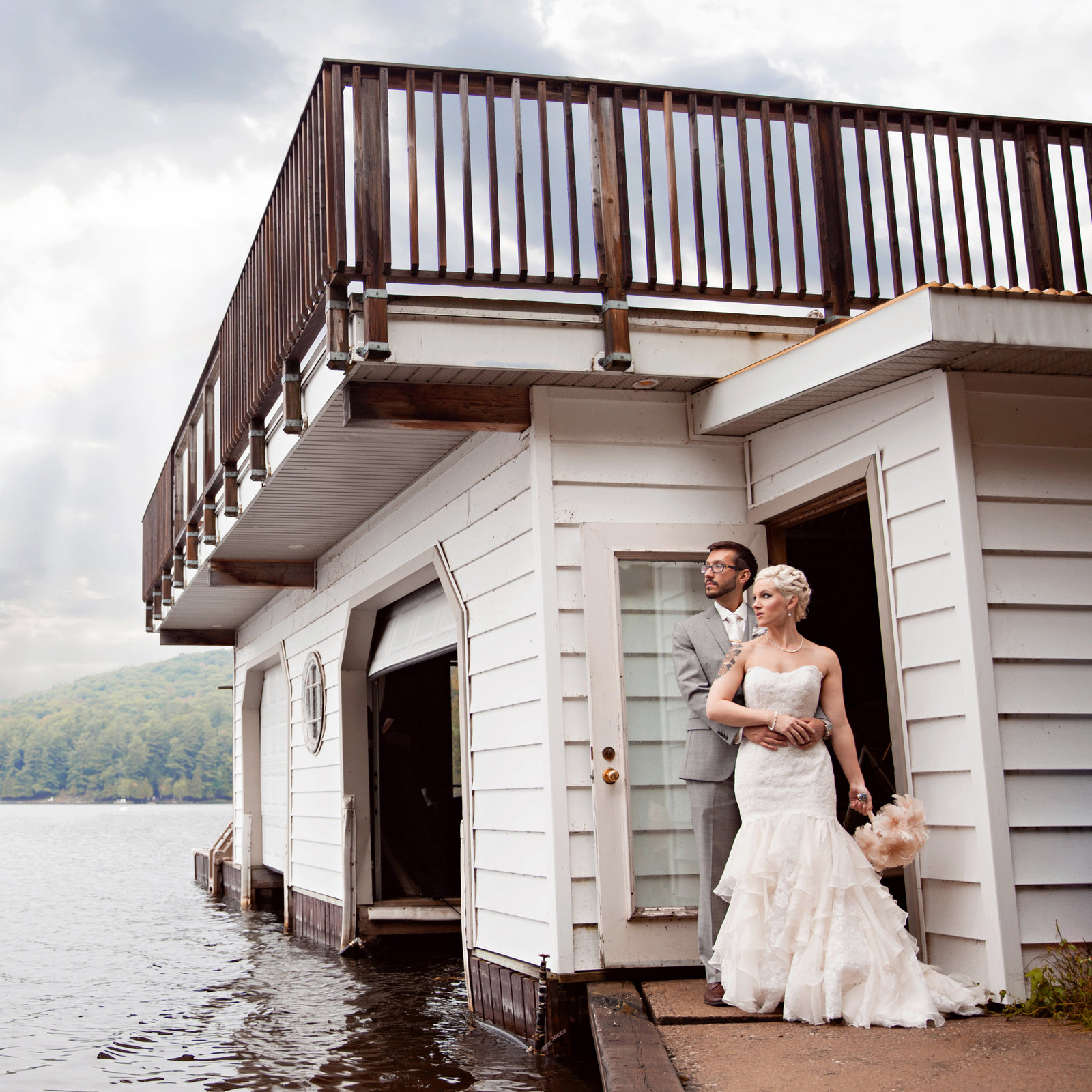 wedding couple standing in front of boat house in Muskoka