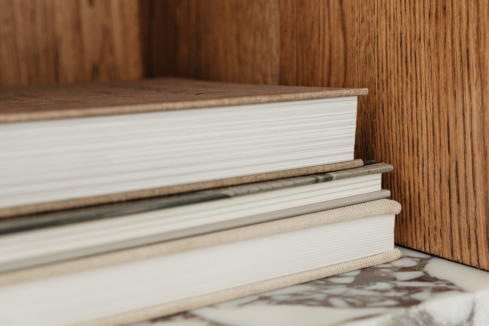 kaboompics_books-on-a-bookcase-marble-shelves-27381