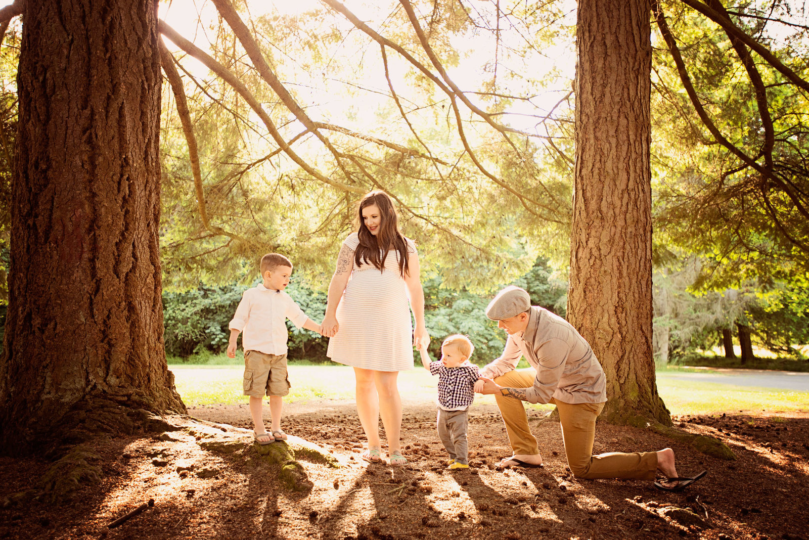 A family standing under trees in the sun
