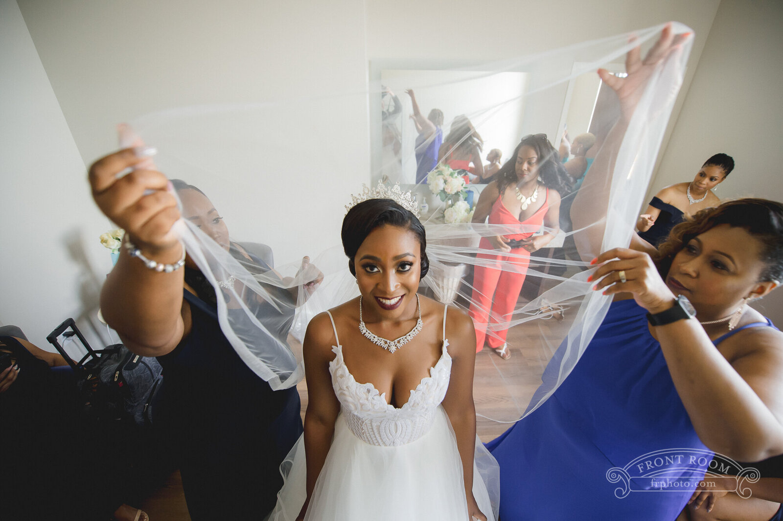 Veil being held about a bride