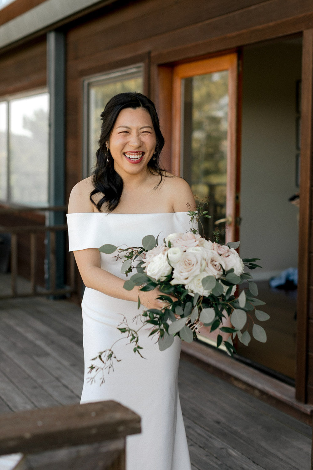 Smiling bride holding her bouquet