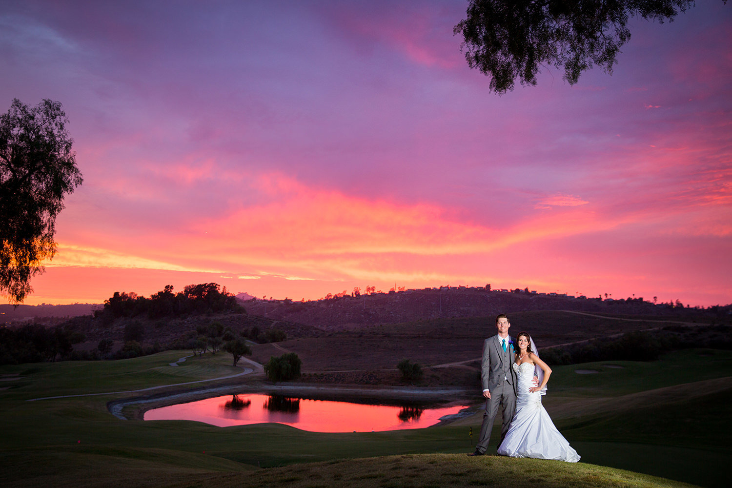 bride and groom at sunset with lake in the background