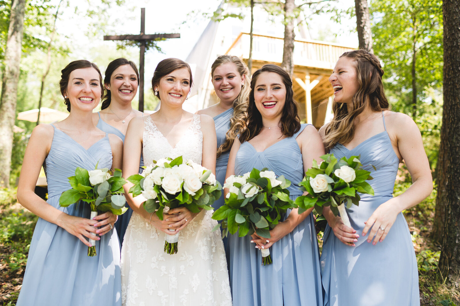 micro weding bridal party laughing with blue dresses and flowers ohio