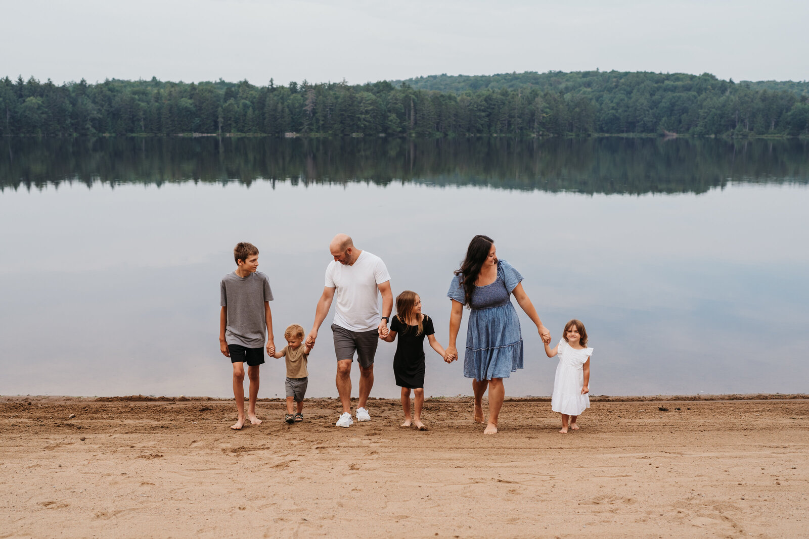 family walking on a beach in old forge