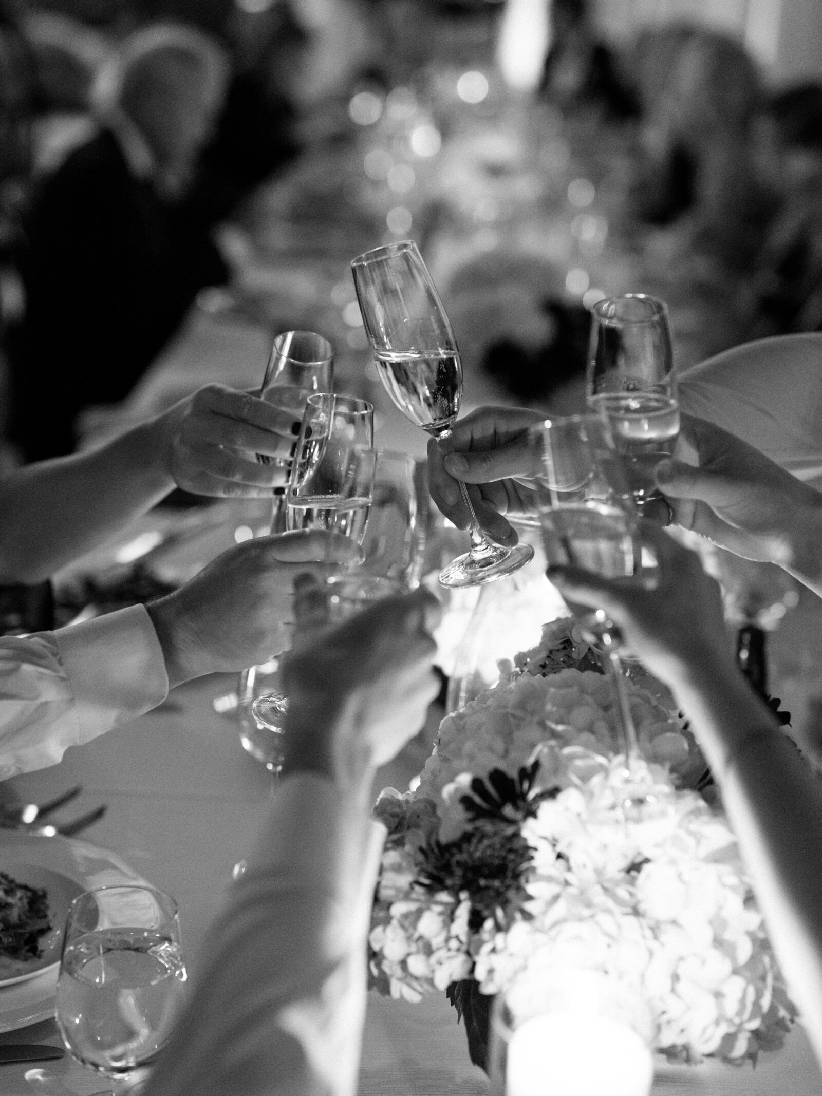 guests cheering with champagne flutes glasses at a wedding reception 