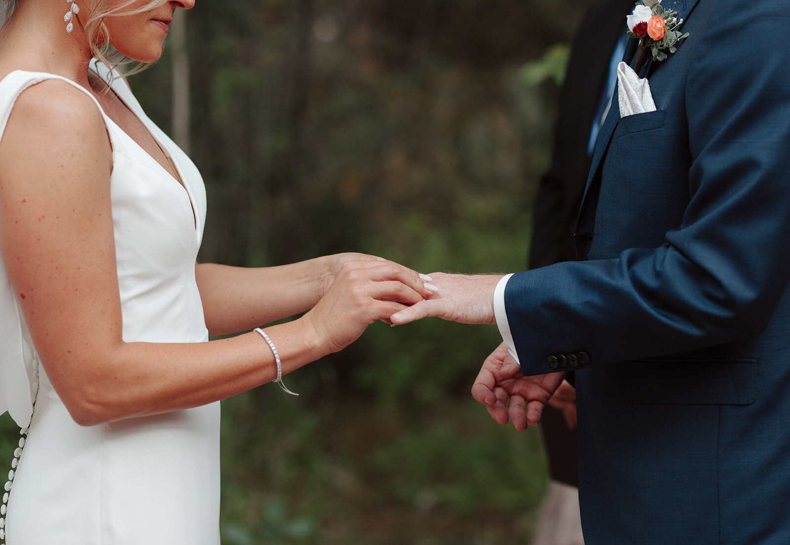 Bride passing the wedding ring to his husband