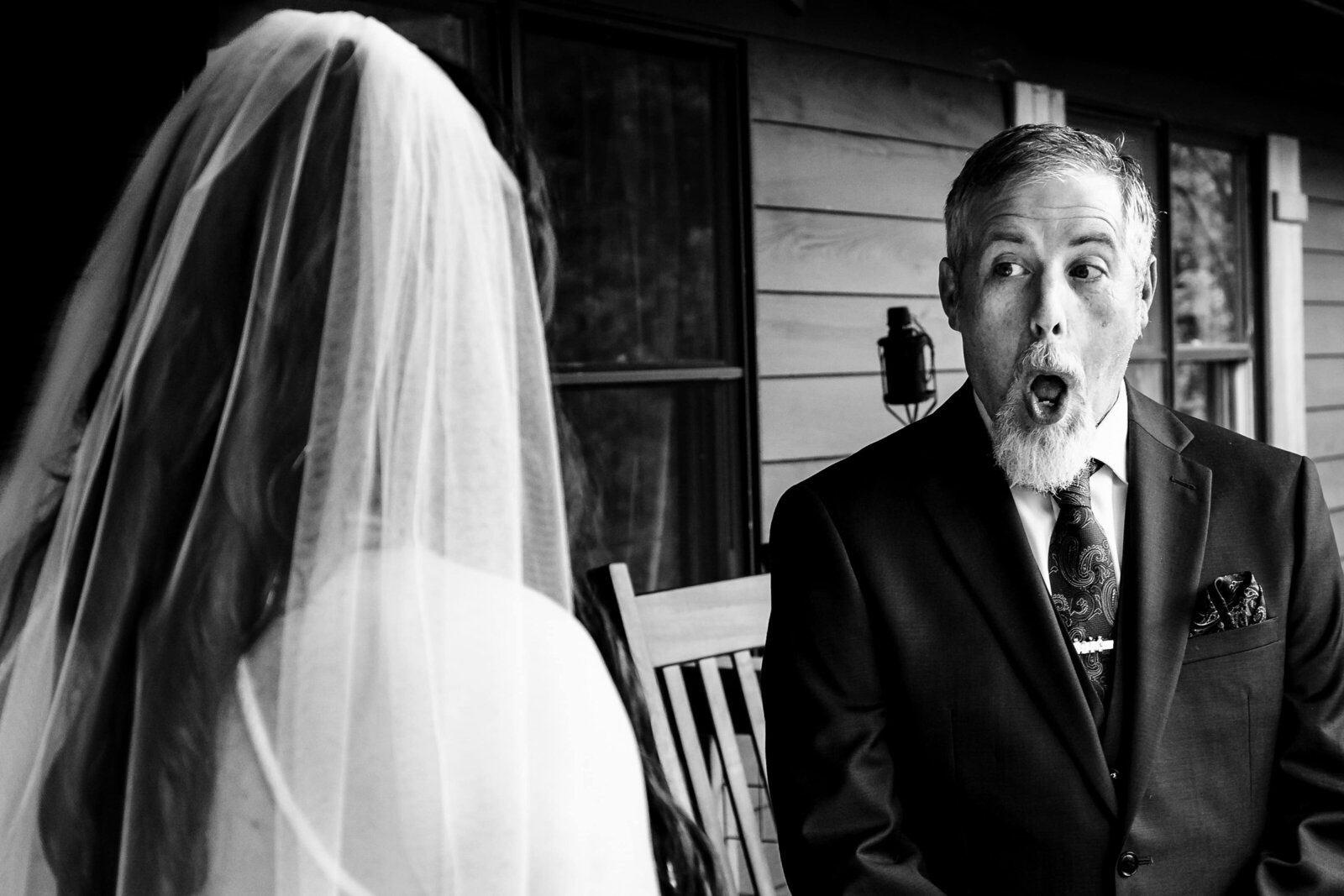 father of the bride reacts as he sees her at the father daughter first look