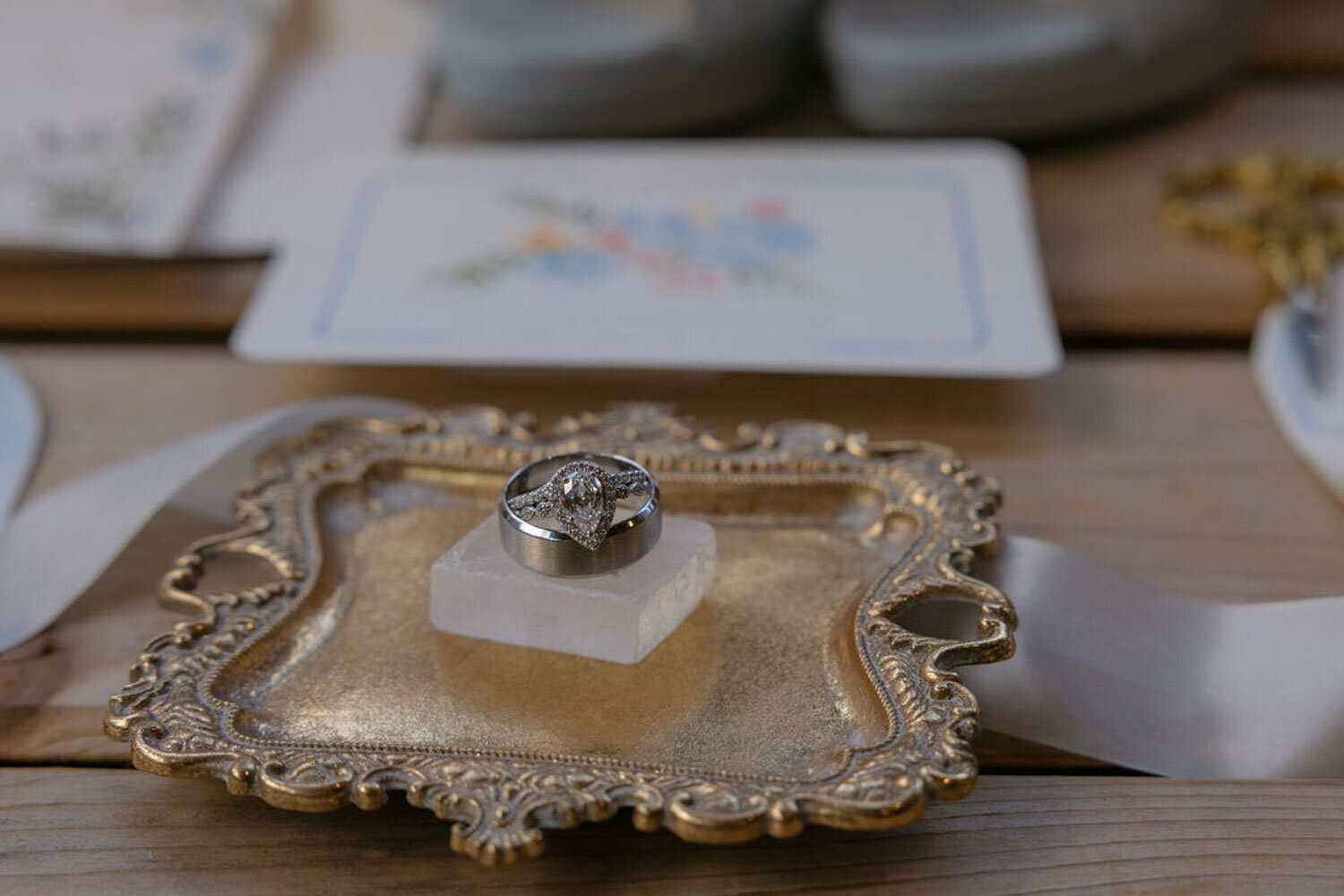 Wedding ring displayed on a vintage gold tray with delicate details