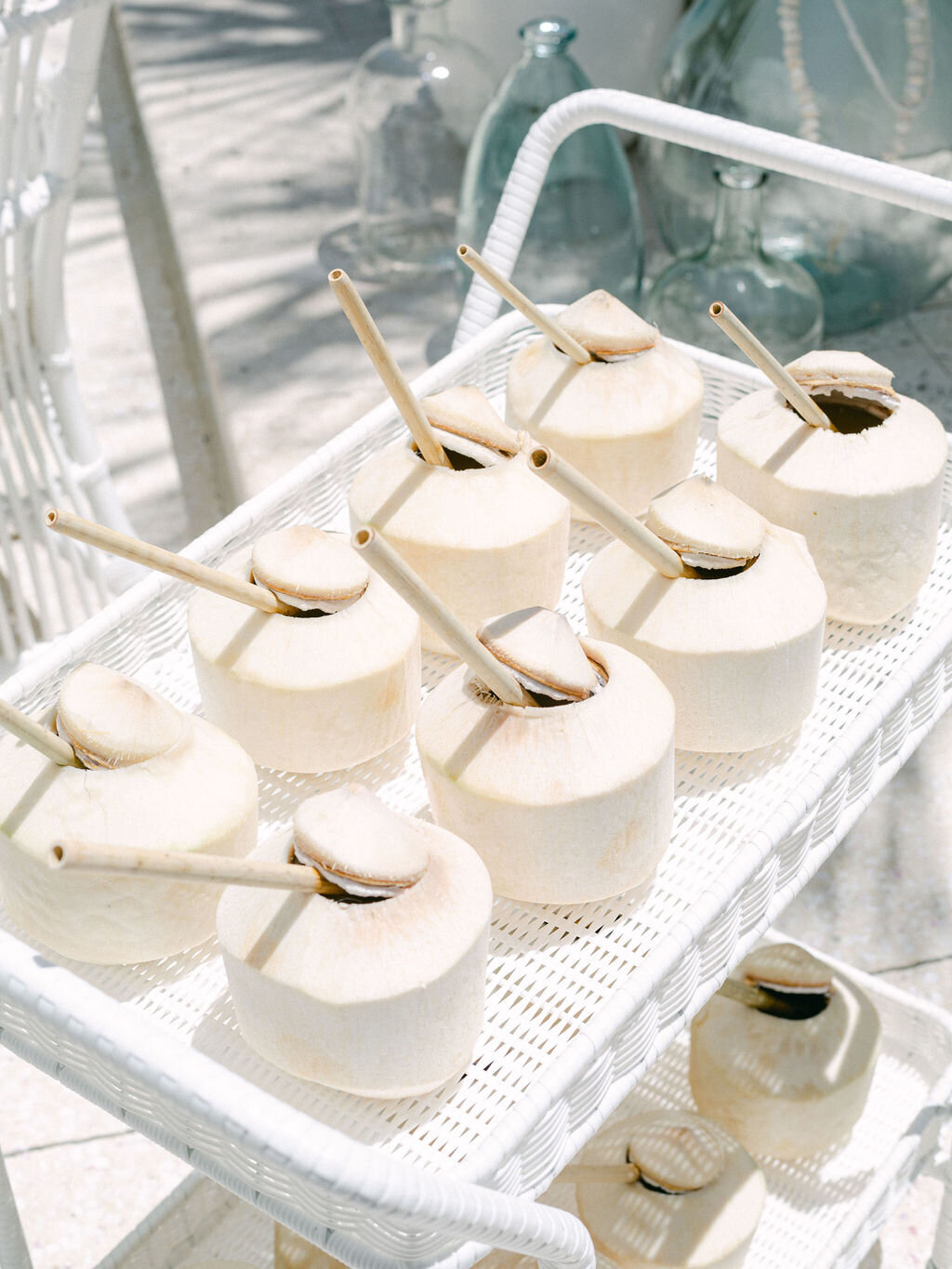 Coconuts with straws for wedding guests at summer wedding at Rosemary beach Florida