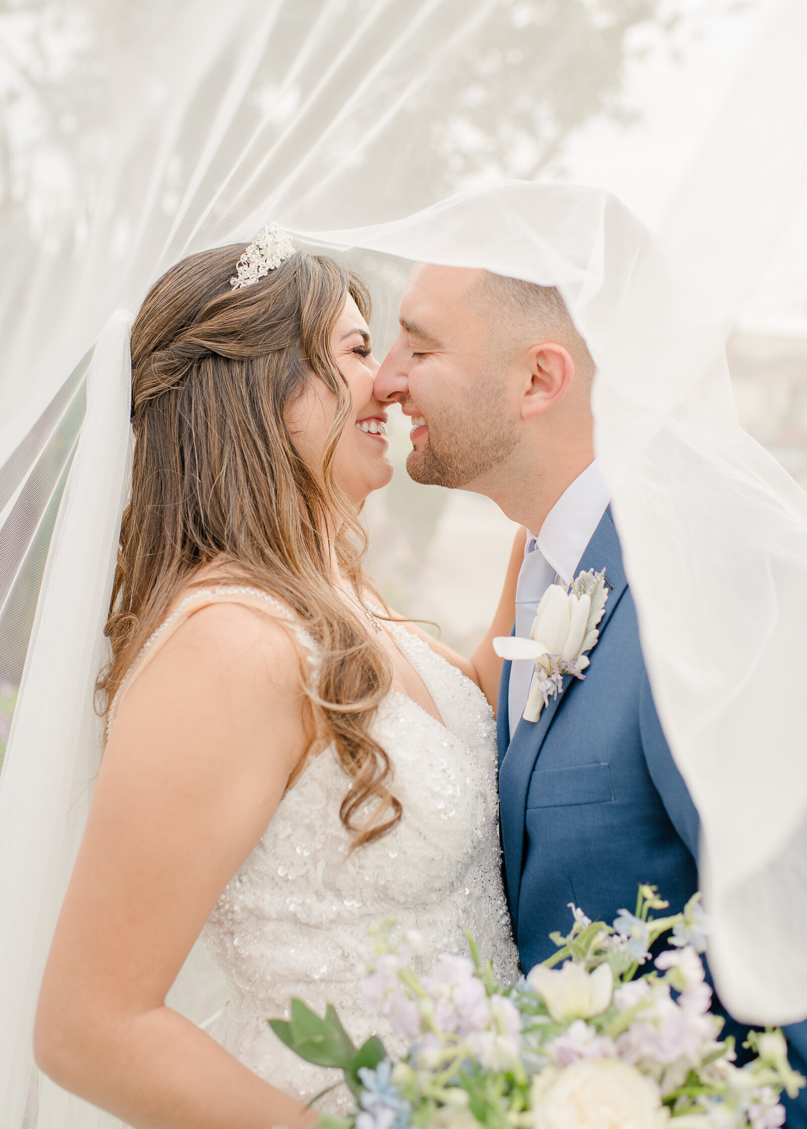 wedding couple under veil at their perry house wedding in monterey