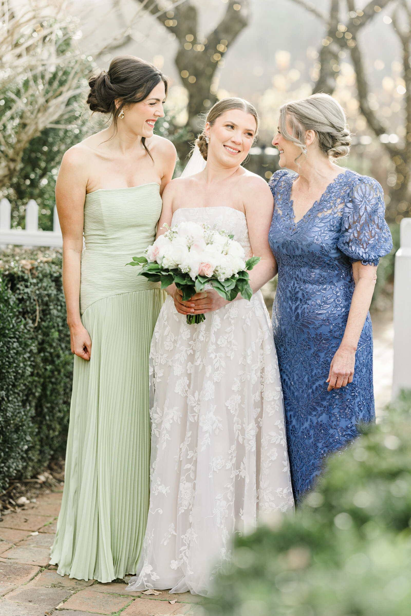Bride, mother, and sister share a heartfelt moment at Inola in Blue Ridge, GA, celebrating family bonds before the wedding ceremony begins.