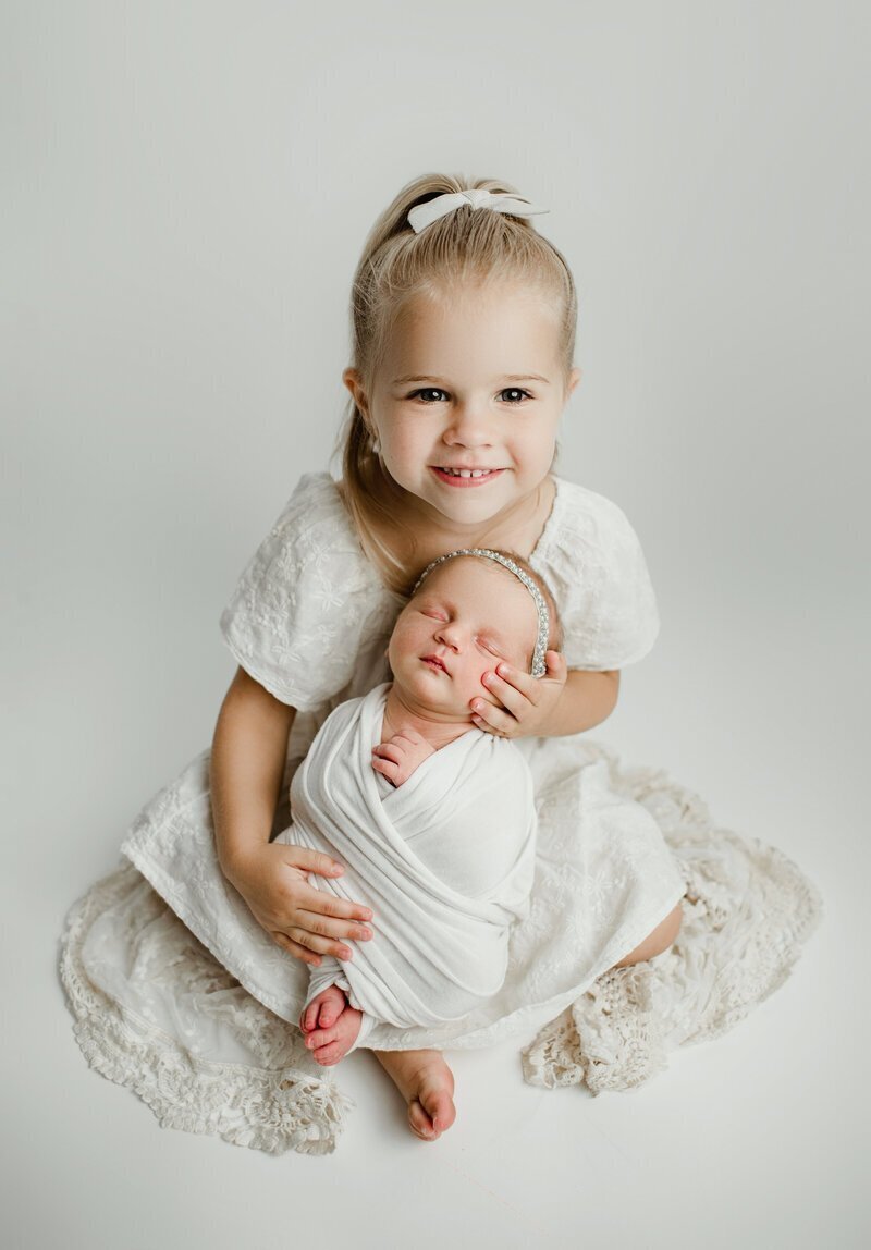 girl with newborn baby to show newborn photography in new jersey
