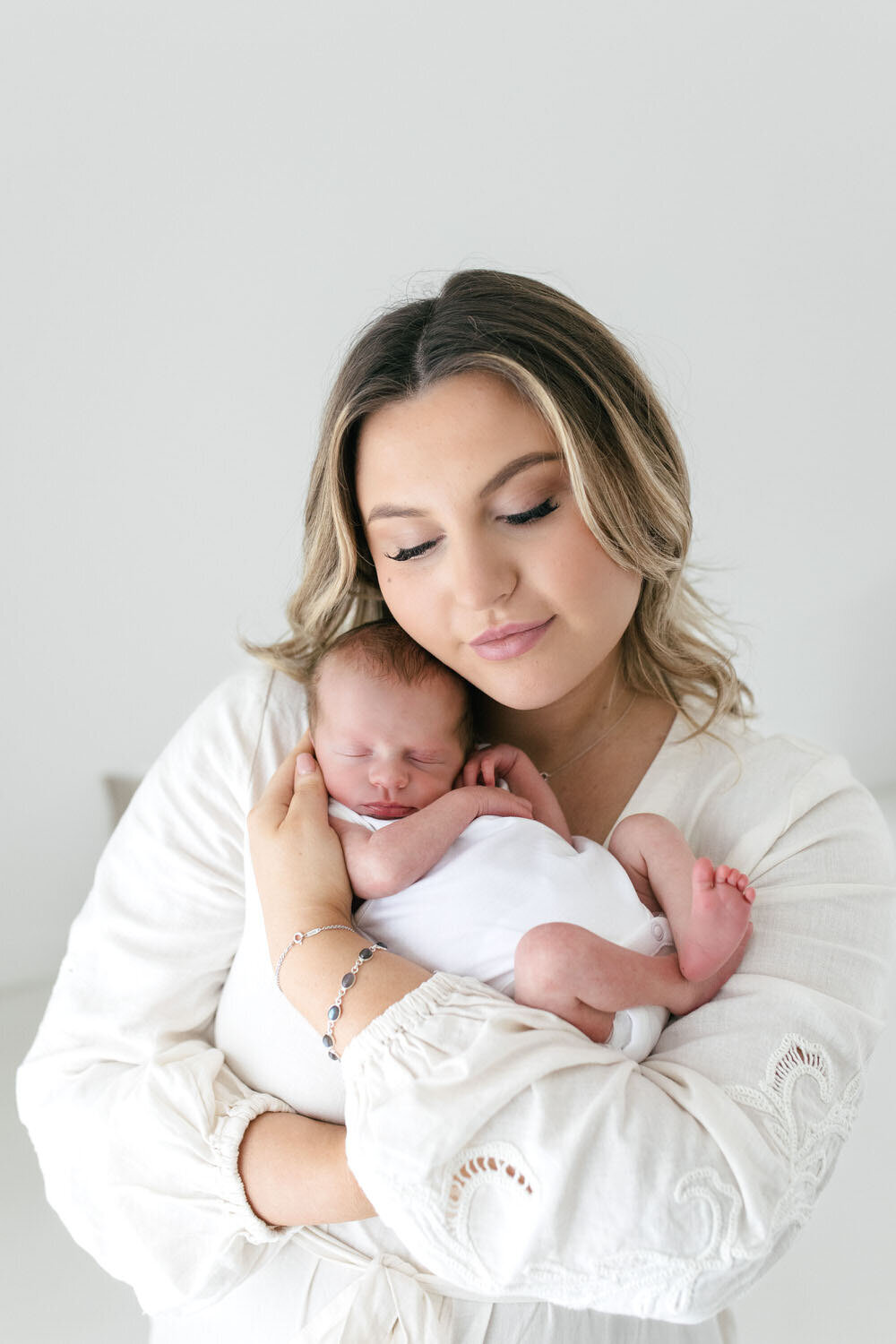 Baby curled up in mothers arms