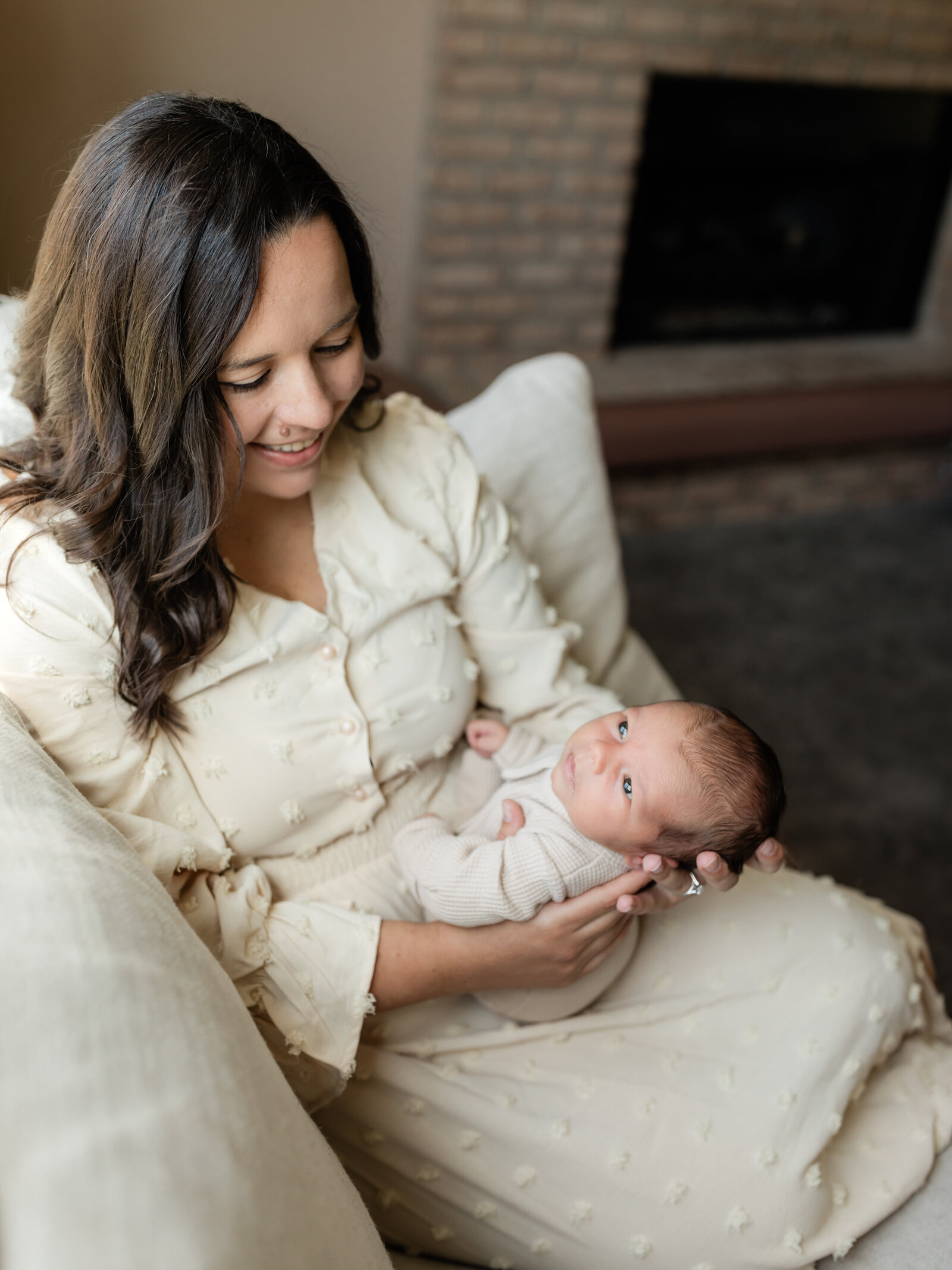 mom holding newborn baby boy for in home newborn session