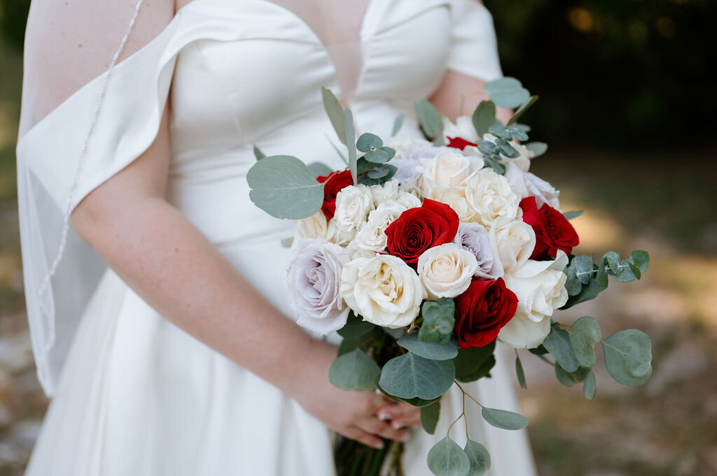 Close up photo of the floral bouquet being held by the bride