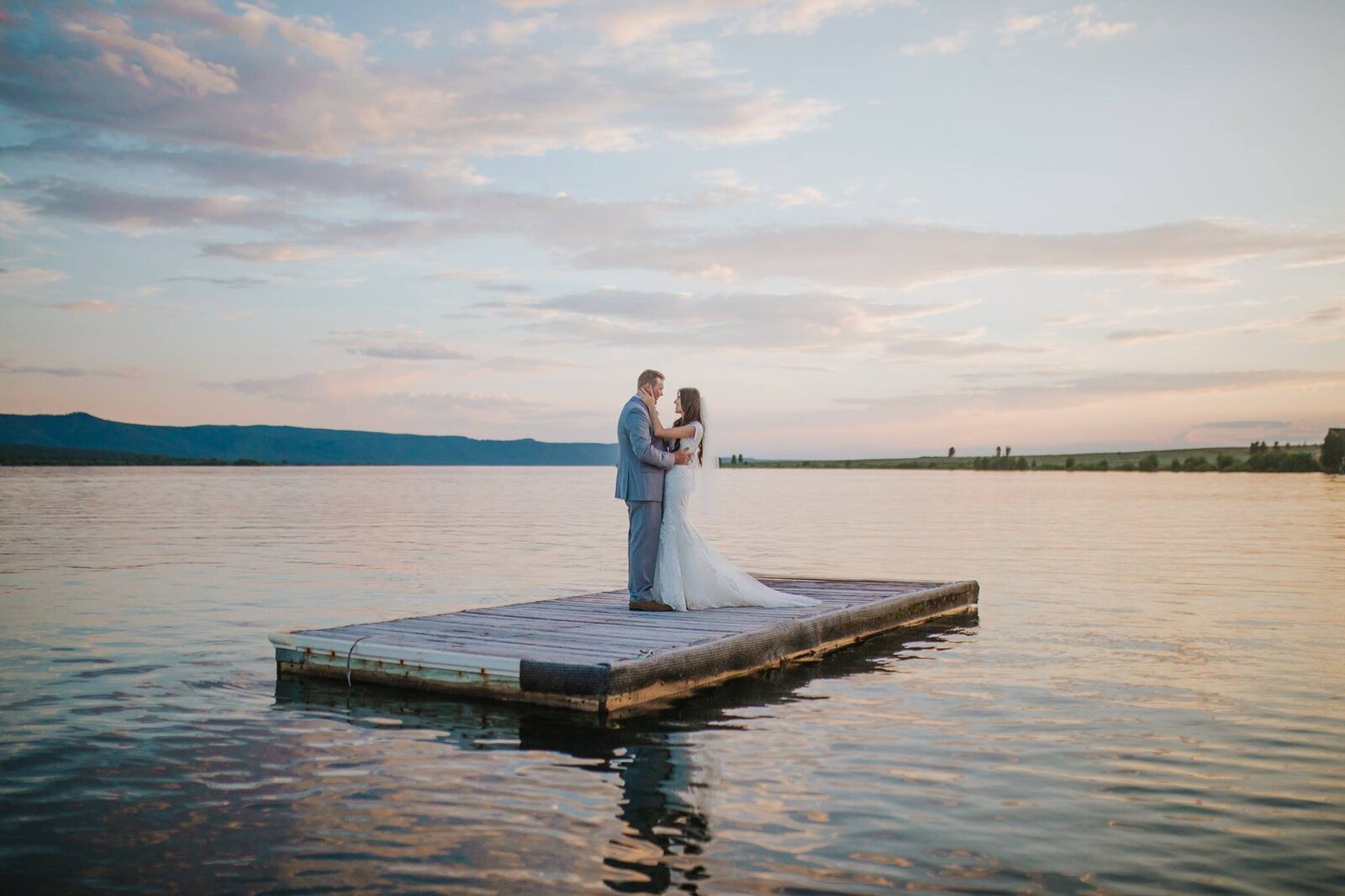 Sacramento Wedding Photographer captures couple standing on dock together after wedding