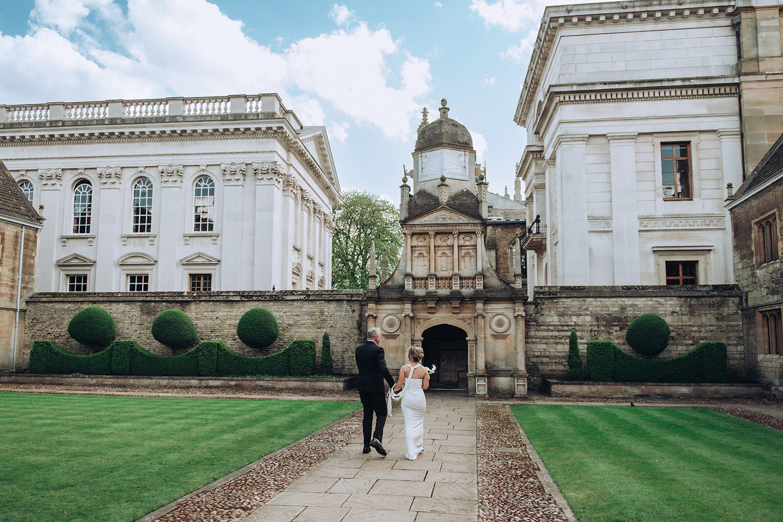 Bride and groom walking into their wedding in Cambridge