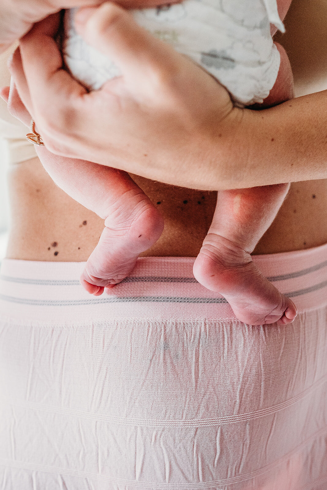 baby feet close up with pink underwear band