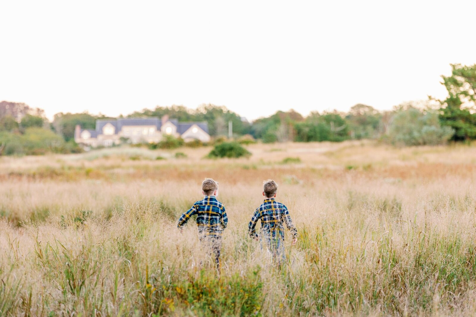 brothers running through field in nantucket