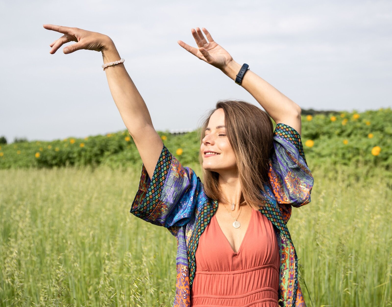 Livia, founder of Liv in the Flow, dancing in nature, embodying the freedom, balance, and well-being that comes with holistic life coaching and stress relief. This image represents the joy of living in alignment with your true self.