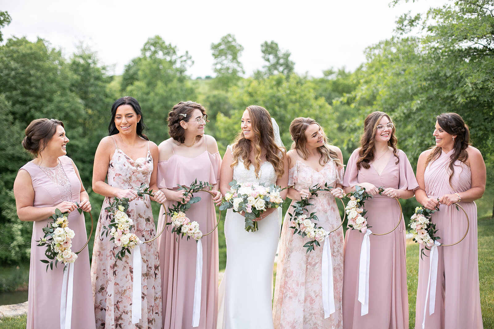 bride and her bridesmaids looking at each other