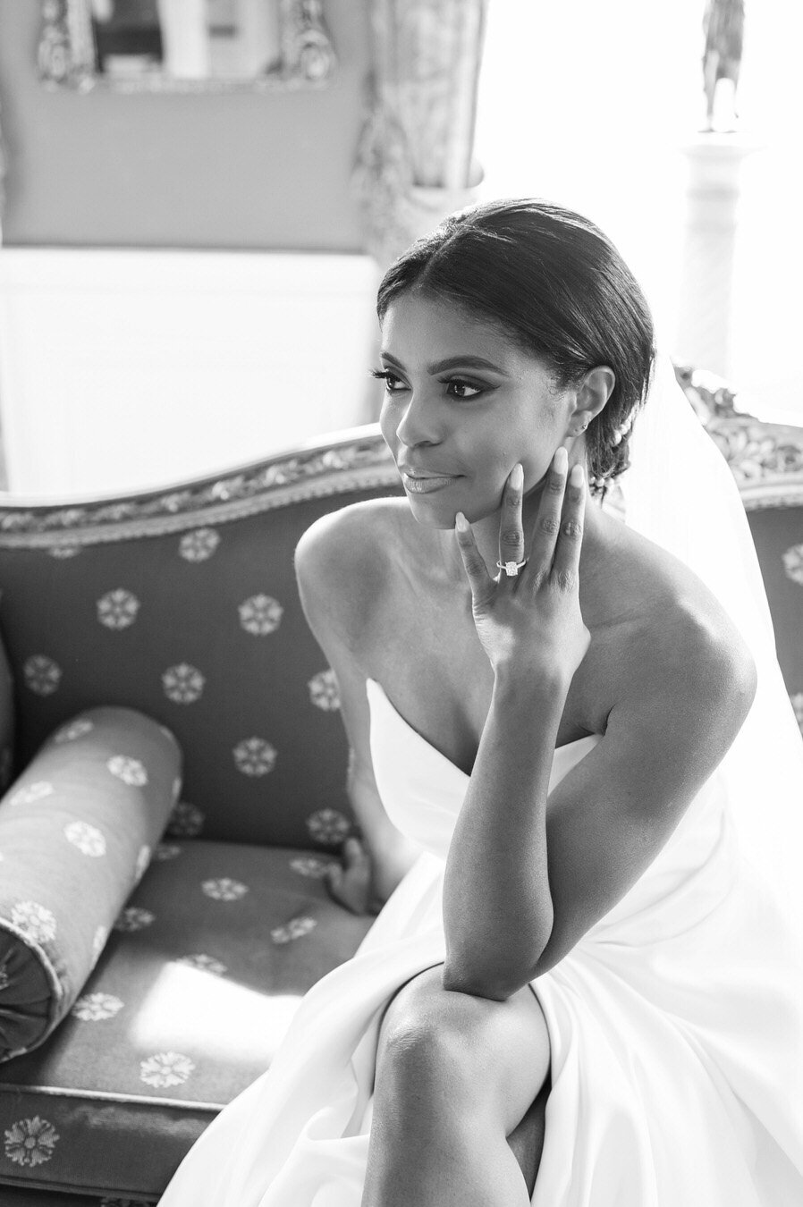 bride looking off while sitting on a couch