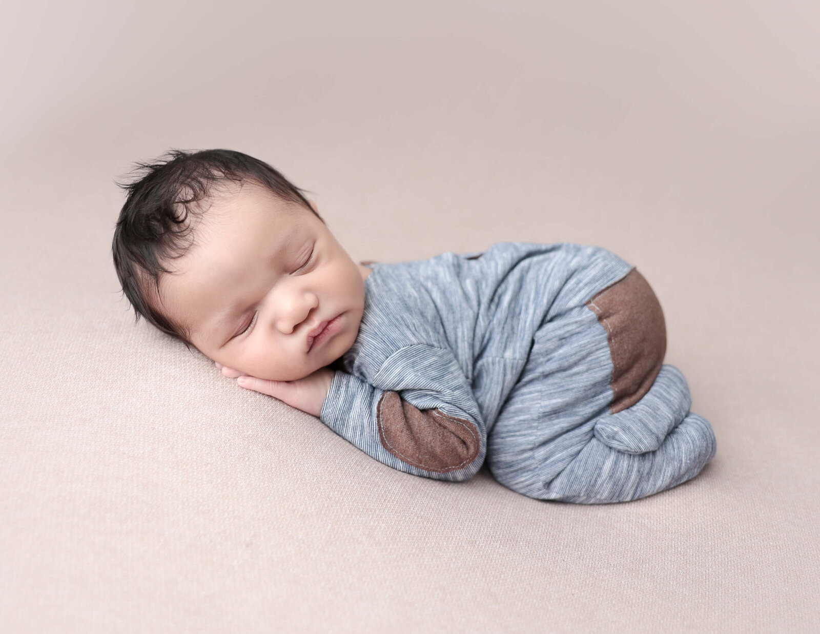 Newborn boy in bum up pose at our in-home studio in Rochester, NY.