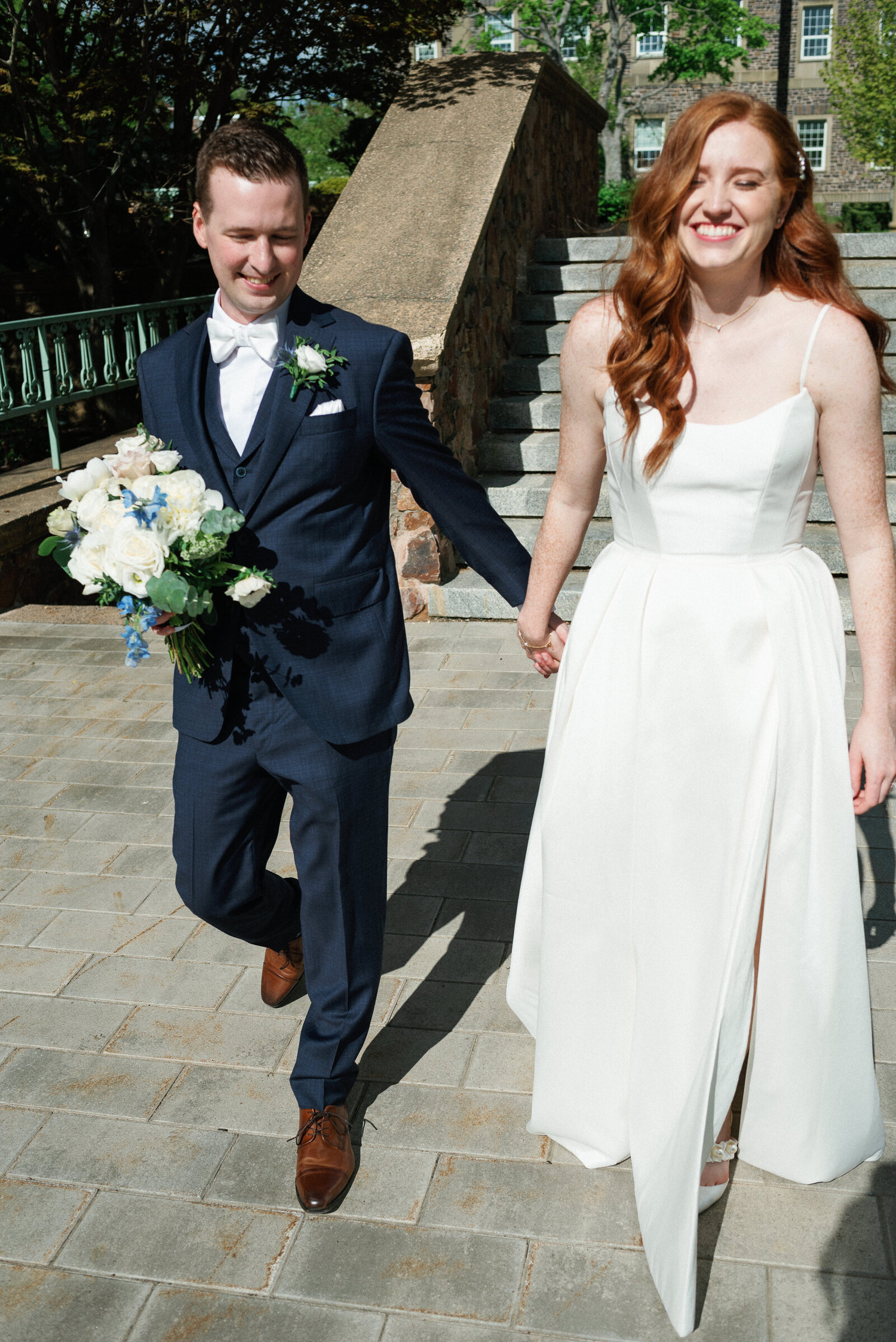 Candid moment of bride and groom walking at Halifax Waterfront.