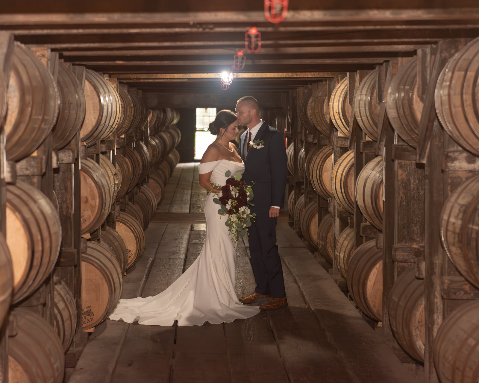 Frankfort bride and groom snuggling at Buffalo Trace in barrel warehouse