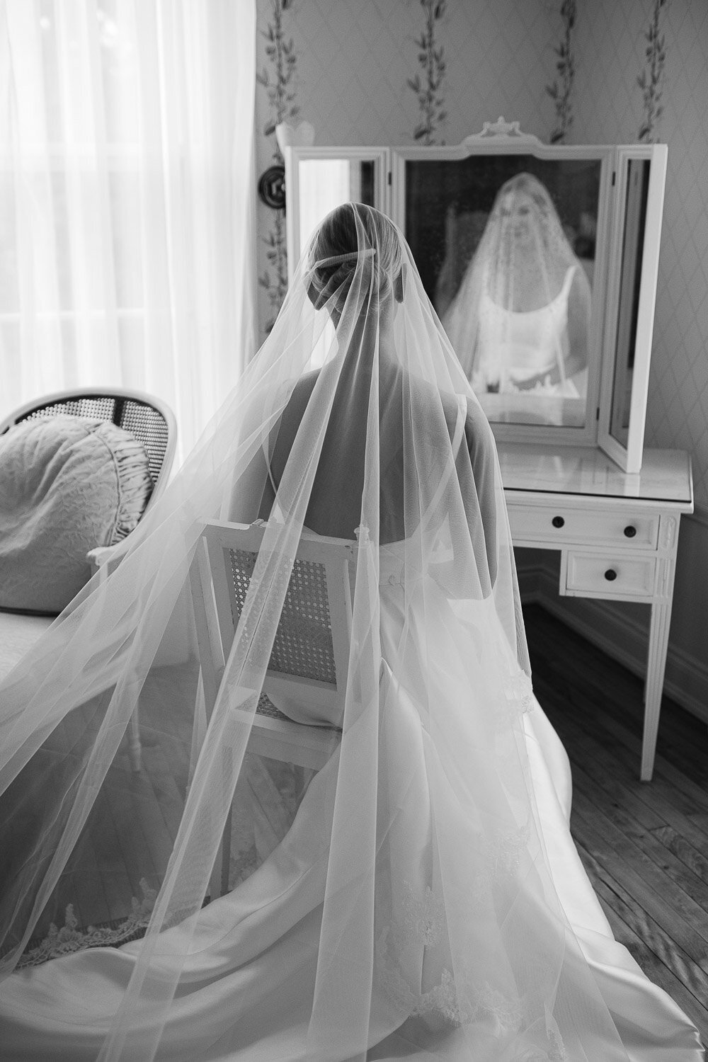 bride sitting at vanity from behind