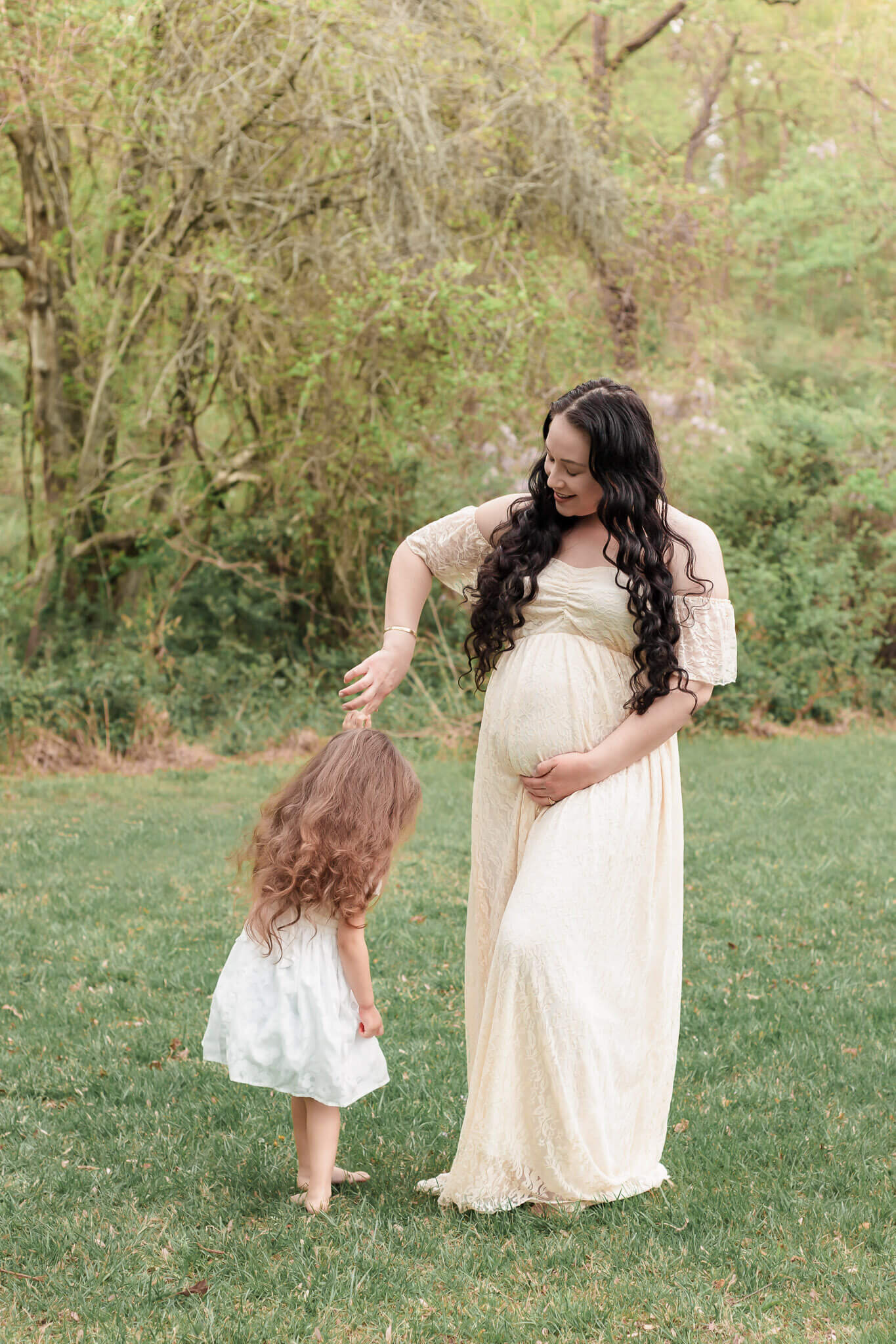 A mom-to-be and her older daughter dancing in a park in Centreville, Virginia.