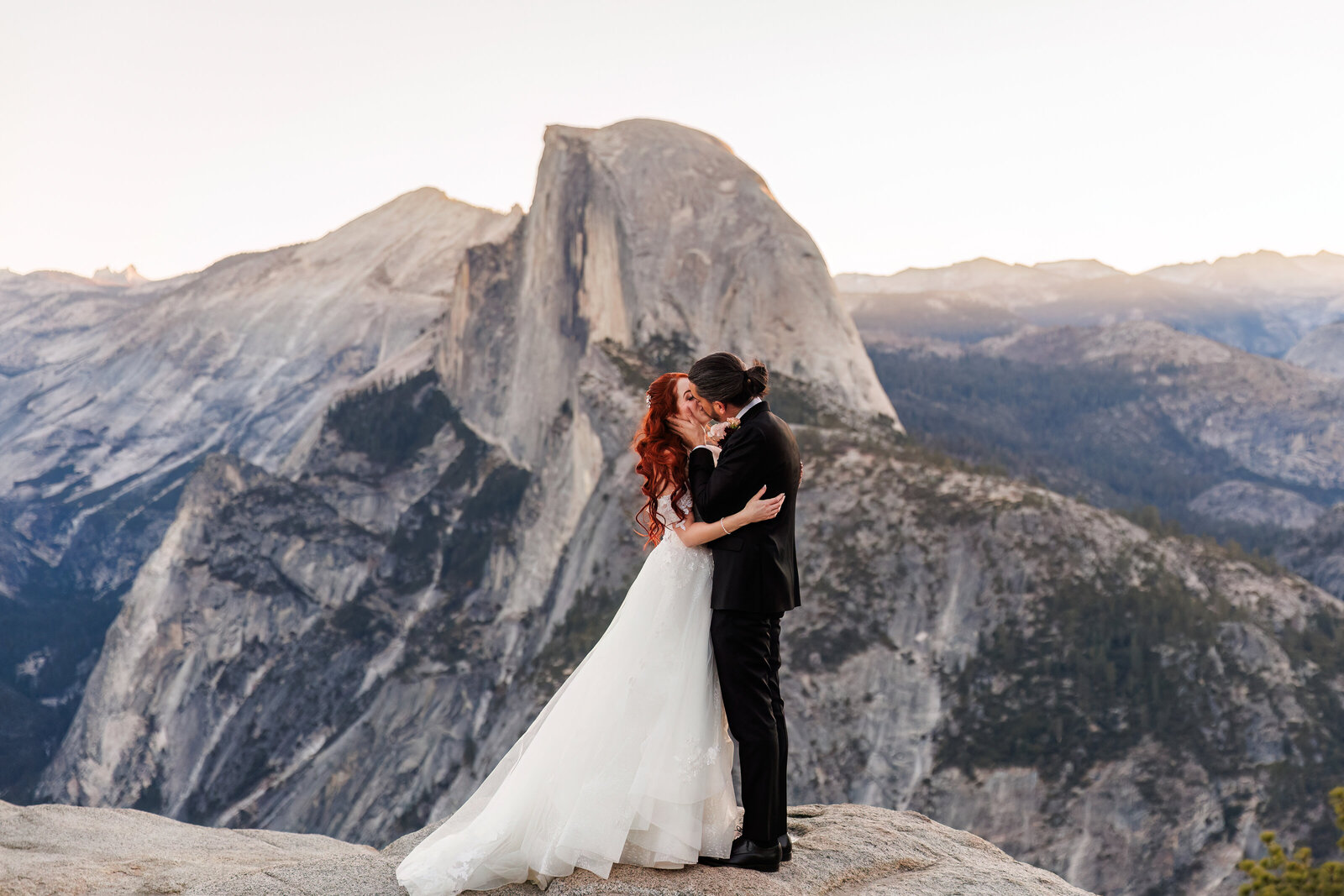 couple kissing at their glacier point elopement