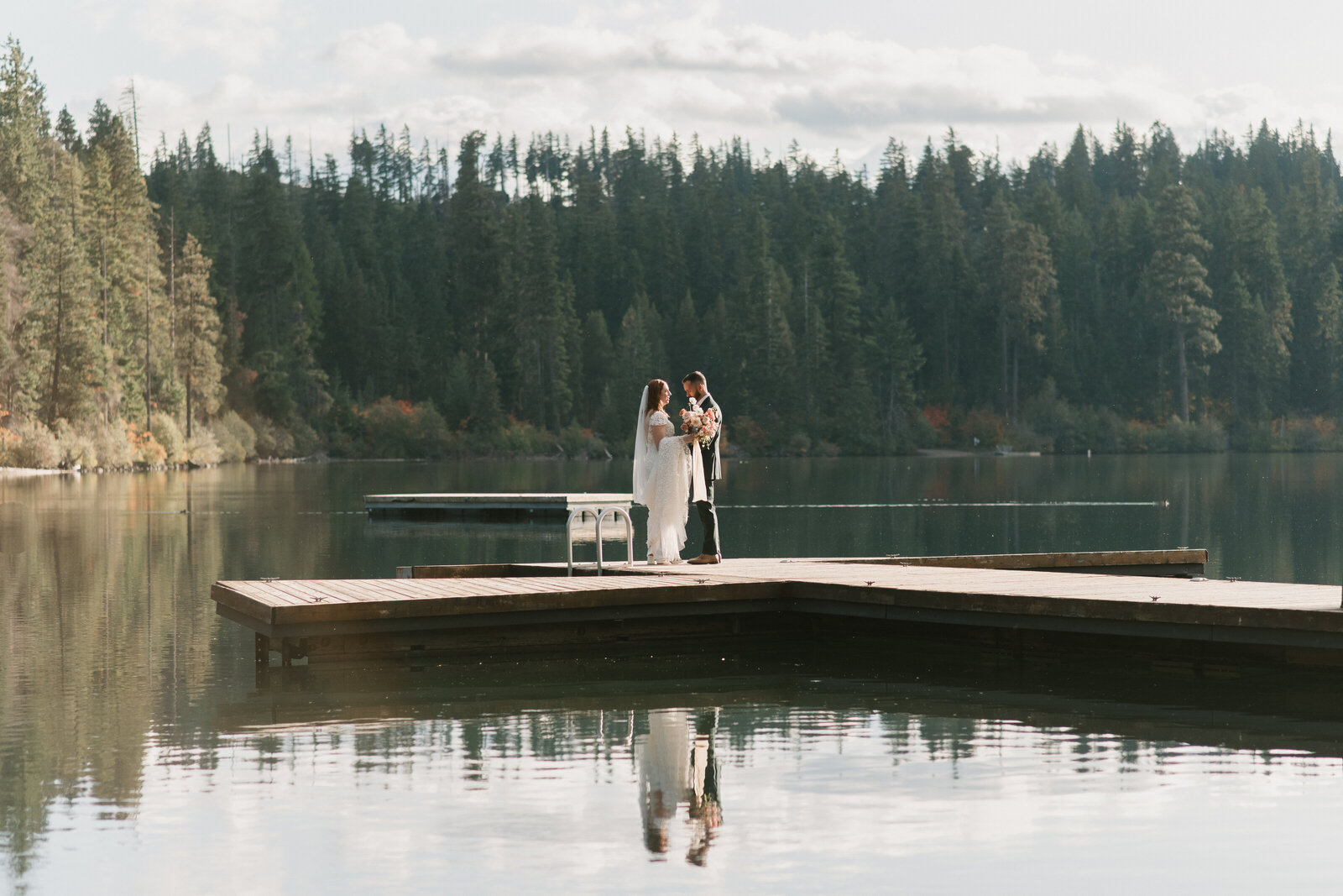 bride and groom portrait in the reflection of Suttle Lake in Oregon
