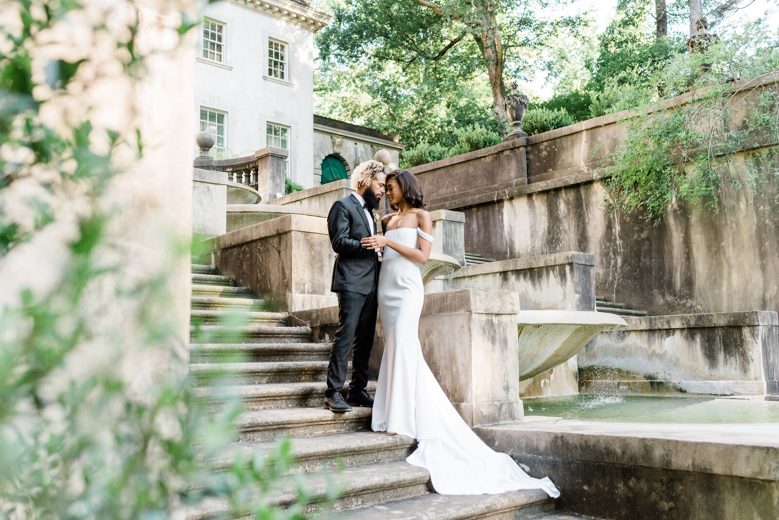 Black Wedding couple touching foreheads and holding hands at the Atlanta Swan House in Atlanta, GA.